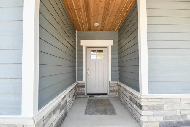 a view of a bathroom with wooden floor and mirror