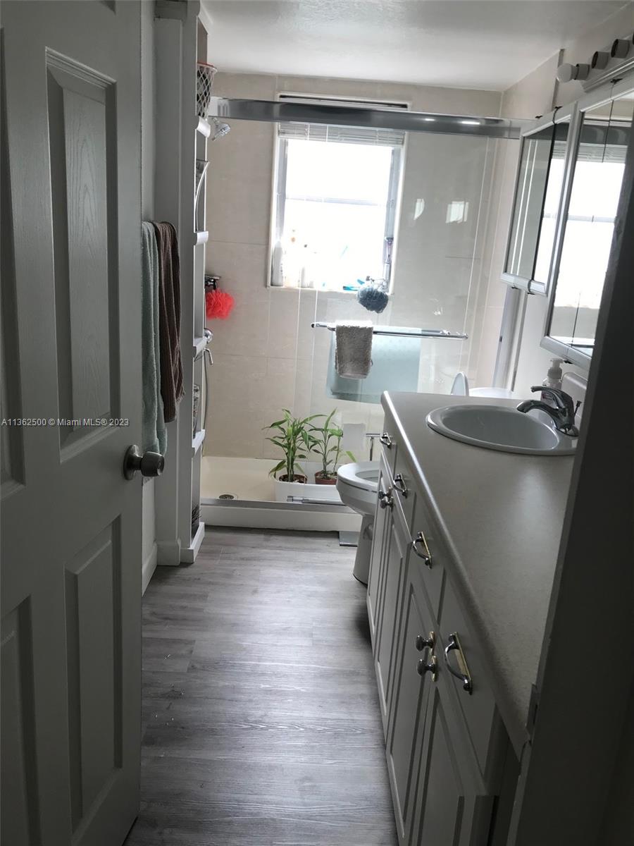 4565 Duhme Road, Unit 105 St. Petersburg, FL 33708 - Photo 13 of 19 a kitchen with sink cabinets and wooden floor