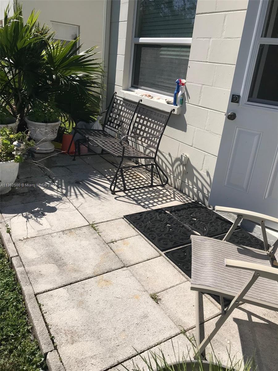 4565 Duhme Road, Unit 105 St. Petersburg, FL 33708 - Photo 19 of 19 a view of a chairs and table in the patio