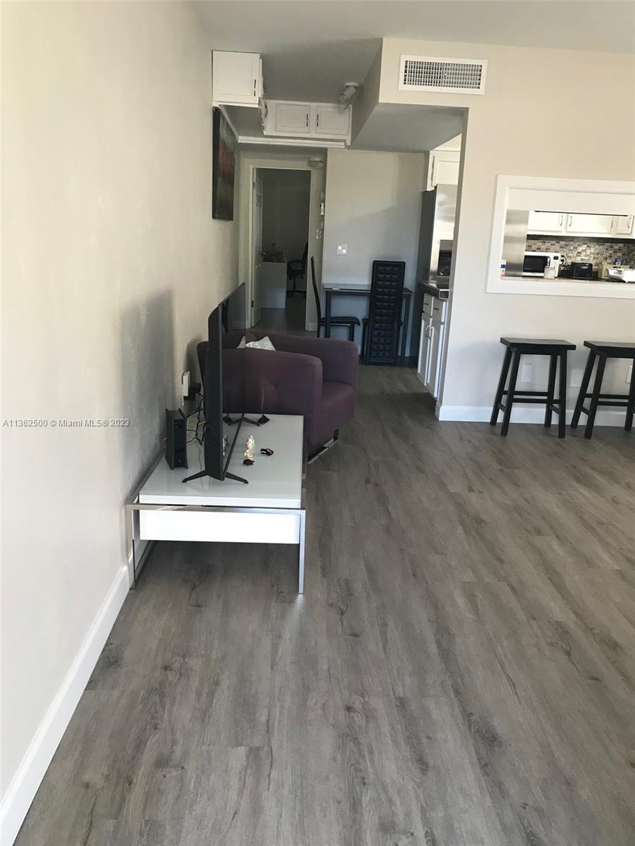 4565 Duhme Road, Unit 105 St. Petersburg, FL 33708 - Photo 2 of 19 a view of kitchen with furniture and wooden floor