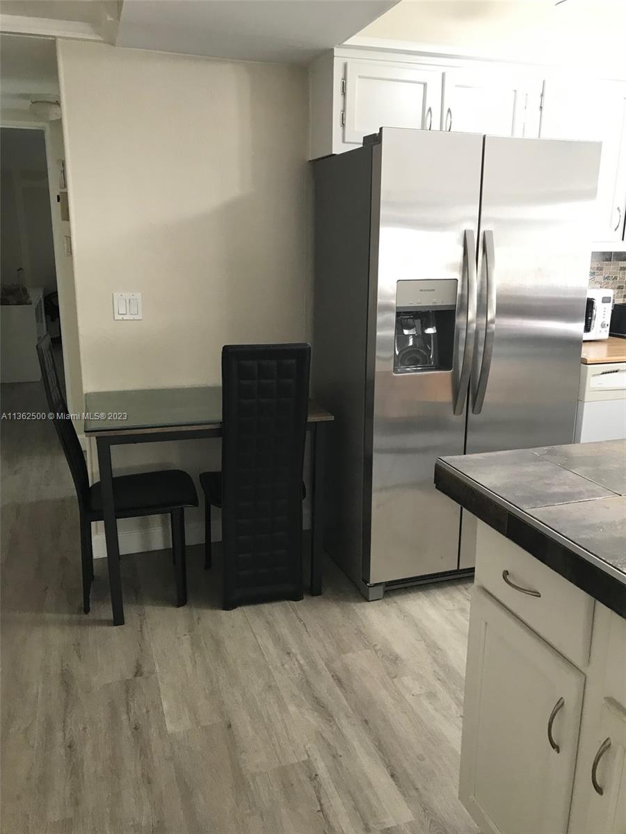 4565 Duhme Road, Unit 105 St. Petersburg, FL 33708 - Photo 4 of 19 a kitchen with stainless steel appliances granite countertop a refrigerator and a stove