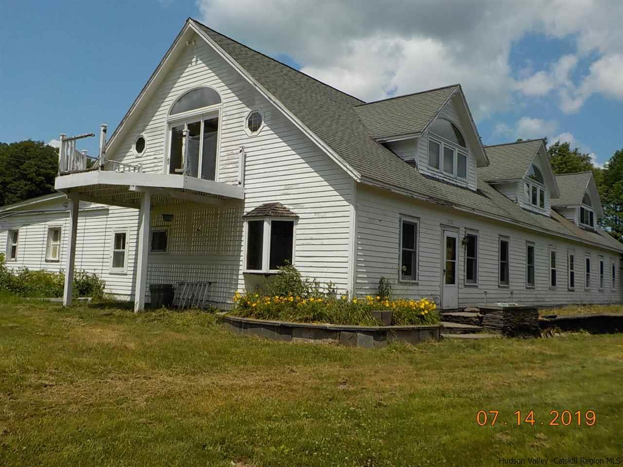 2199 Burroughs Memorial Road Roxbury, NY 12474 - Photo 1 of 34 a front view of a house with a yard