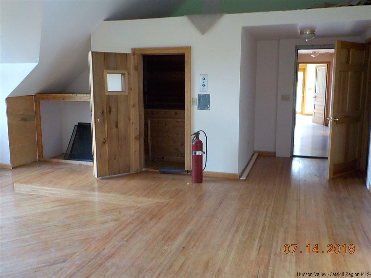 2199 Burroughs Memorial Road Roxbury, NY 12474 - Photo 11 of 34 an empty room with wooden floor and windows