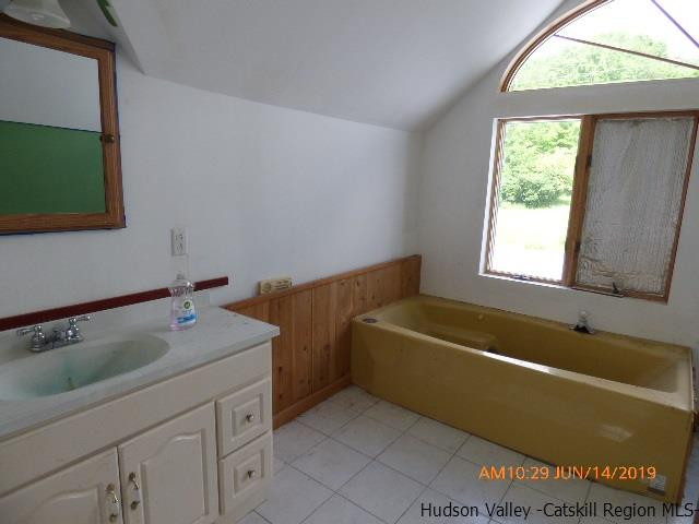 2199 Burroughs Memorial Road Roxbury, NY 12474 - Photo 19 of 34 a bathroom with a tub sink and mirror