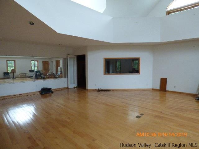 2199 Burroughs Memorial Road Roxbury, NY 12474 - Photo 2 of 34 a view of an empty room and kitchen space with wooden floor