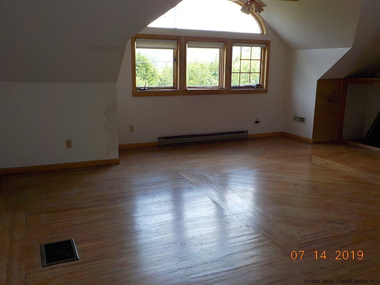 2199 Burroughs Memorial Road Roxbury, NY 12474 - Photo 4 of 34 an empty room with wooden floor and windows