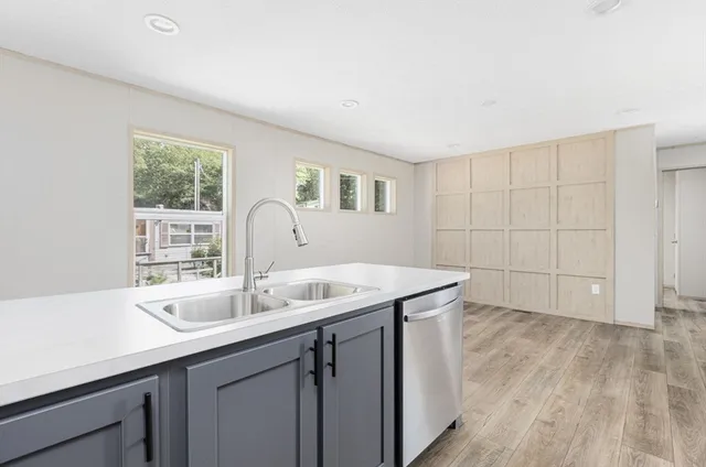 a kitchen with a sink and cabinets