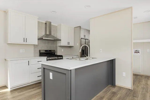 a kitchen with a sink a stove and cabinets