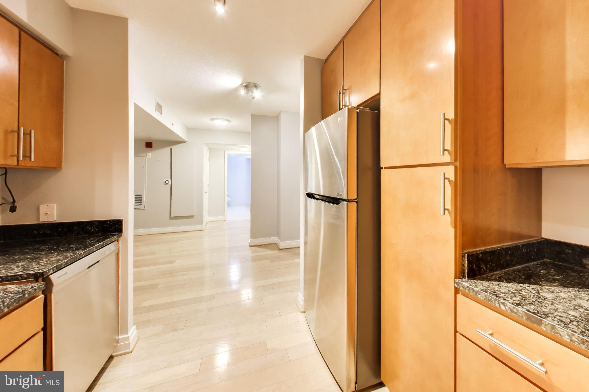 915 E Street Northwest, Unit 414 Washington, DC 20004 - Photo 12 of 35 a kitchen with a refrigerator and a sink