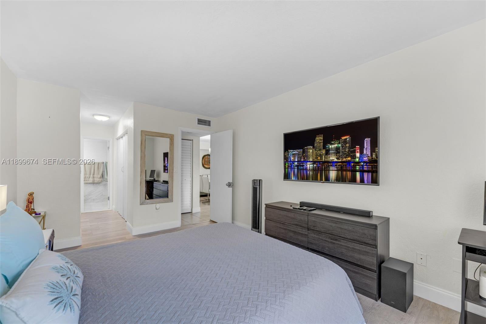9437 Southwest 76th Street, Unit V25 Miami, FL 33173 - Photo 16 of 30 a bedroom with furniture and a flat screen tv