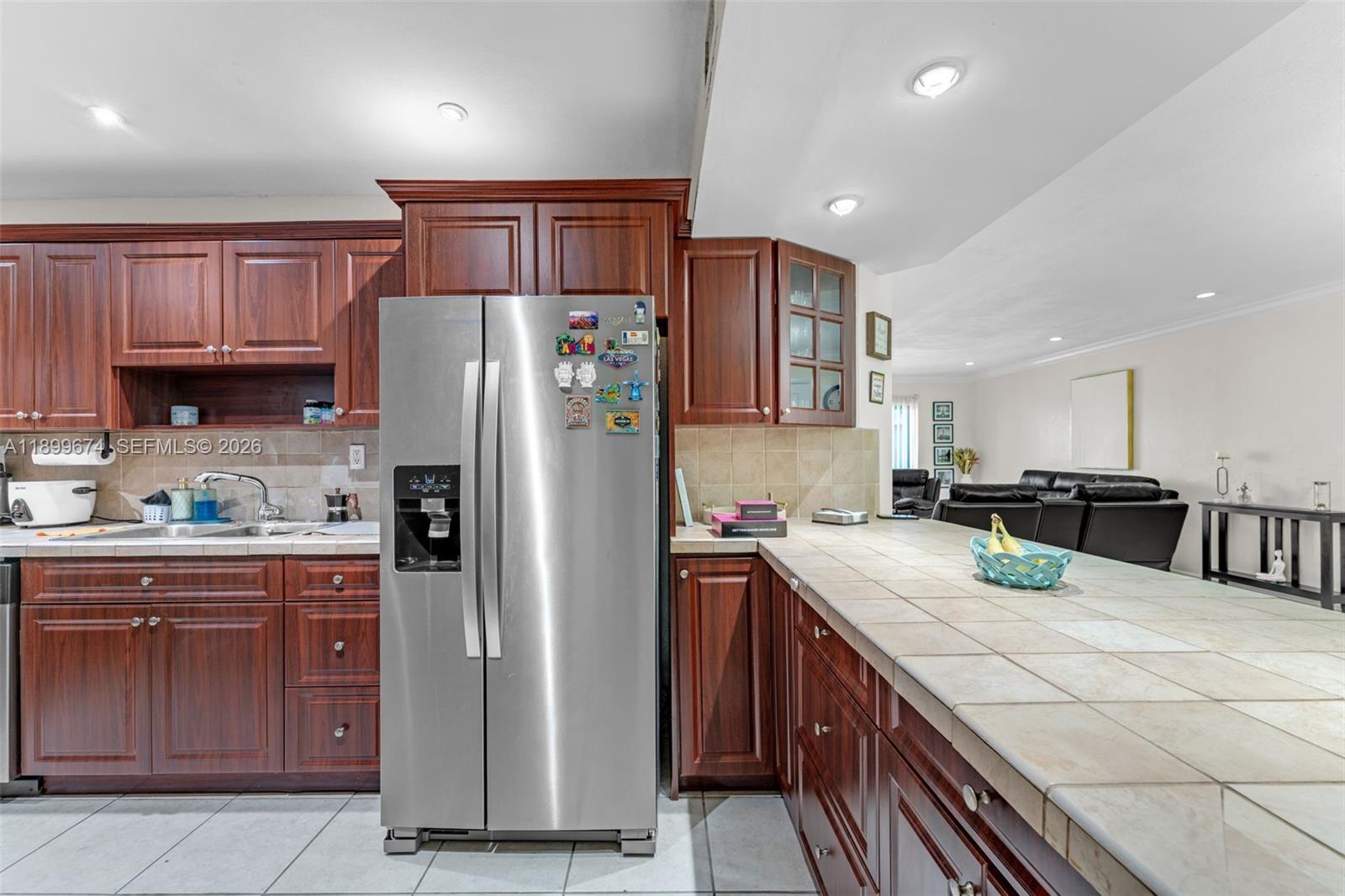9437 Southwest 76th Street, Unit V25 Miami, FL 33173 - Photo 2 of 30 a kitchen with stainless steel appliances granite countertop a refrigerator a sink and a stove