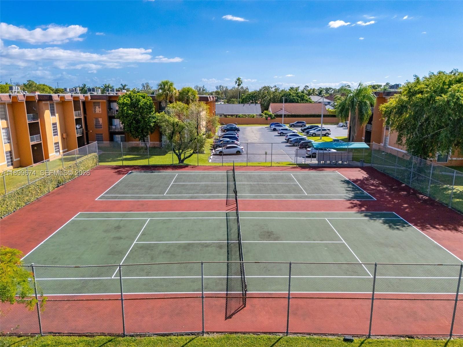 9437 Southwest 76th Street, Unit V25 Miami, FL 33173 - Photo 26 of 30 a view of a tennis court
