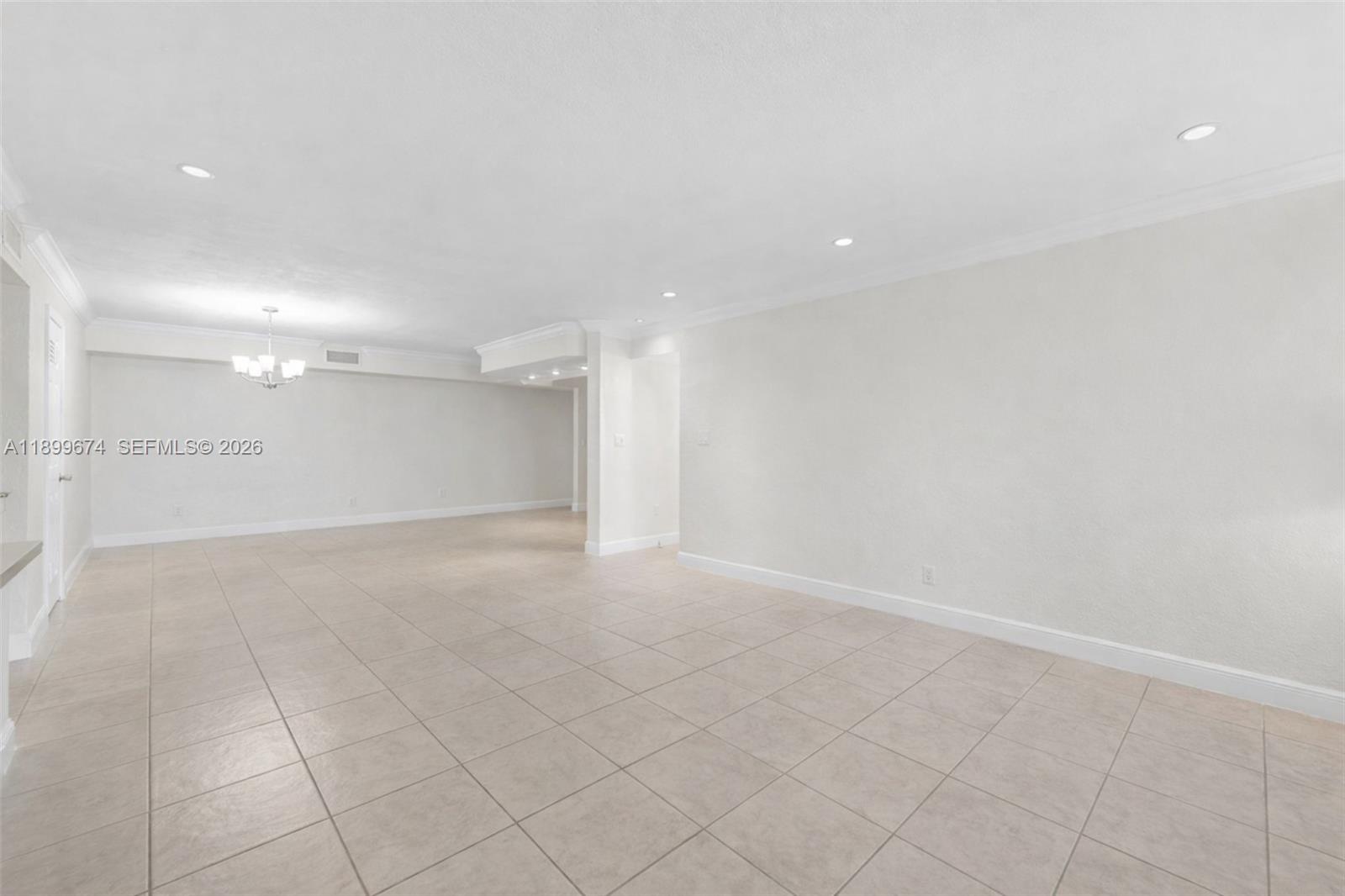 9437 Southwest 76th Street, Unit V25 Miami, FL 33173 - Photo 5 of 30 an empty room with white walls and tiles