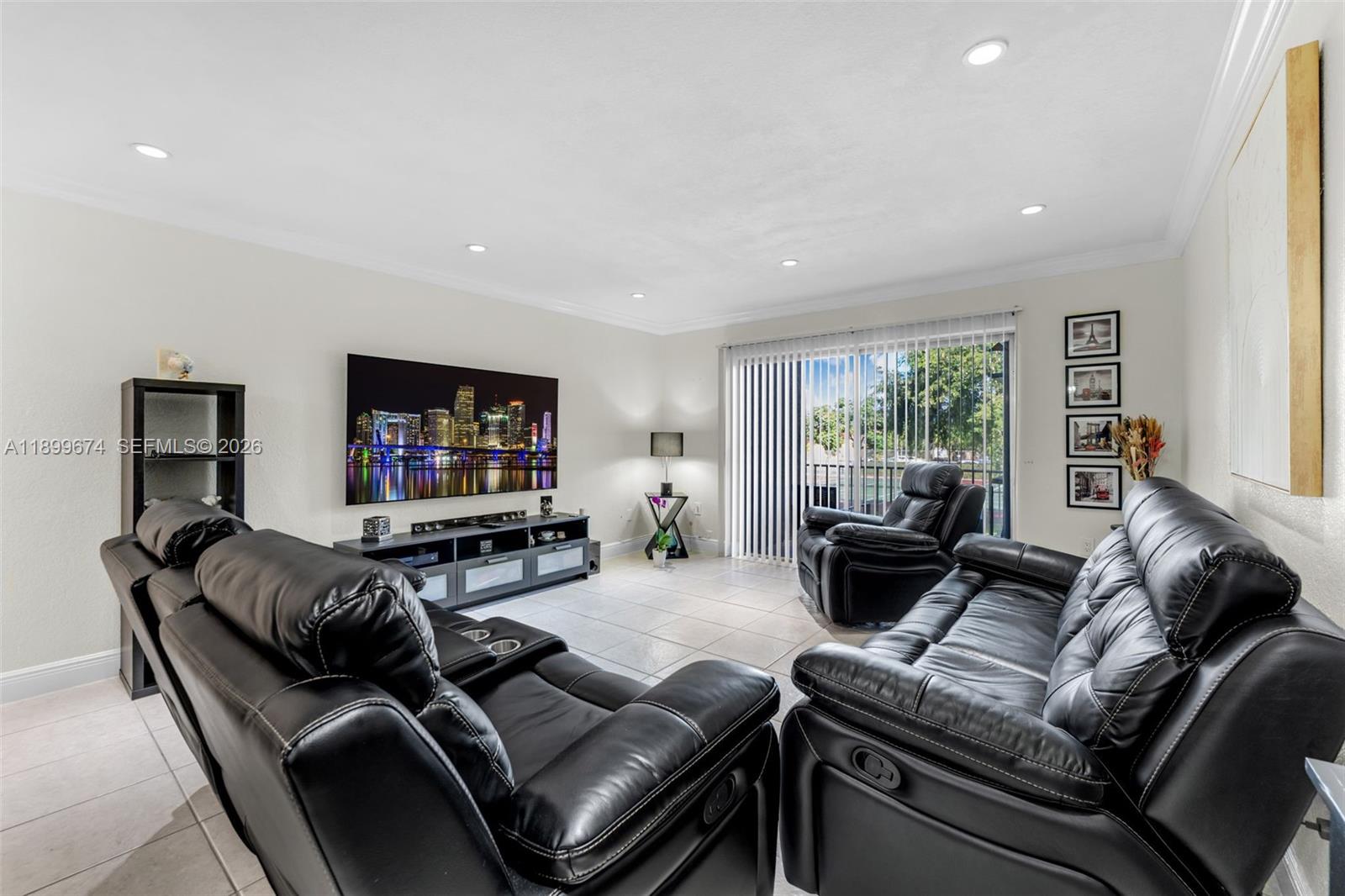9437 Southwest 76th Street, Unit V25 Miami, FL 33173 - Photo 7 of 30 a living room with furniture and a flat screen tv