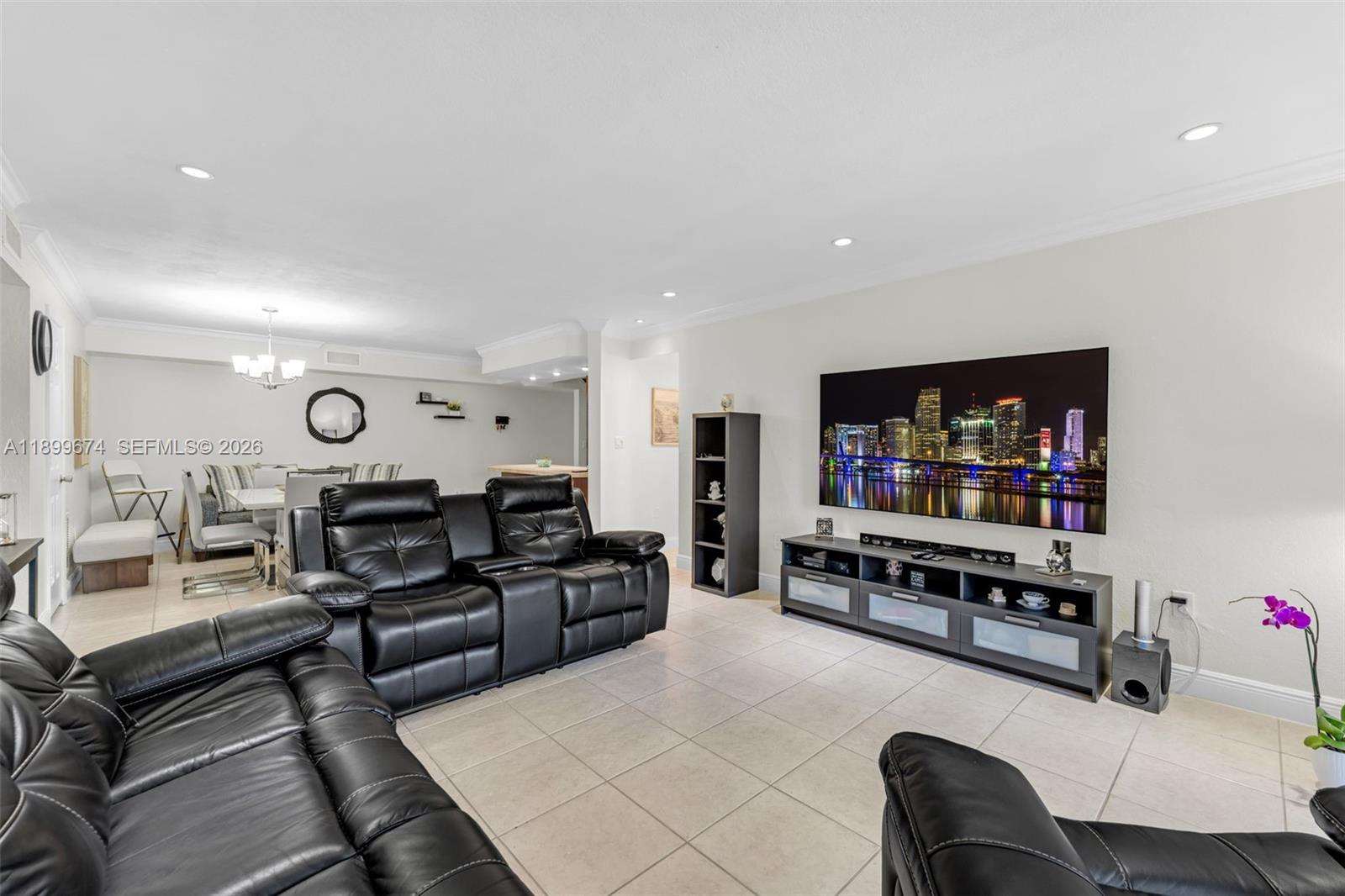 9437 Southwest 76th Street, Unit V25 Miami, FL 33173 - Photo 8 of 30 a living room with furniture and a flat screen tv