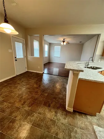 a view of kitchen and empty room