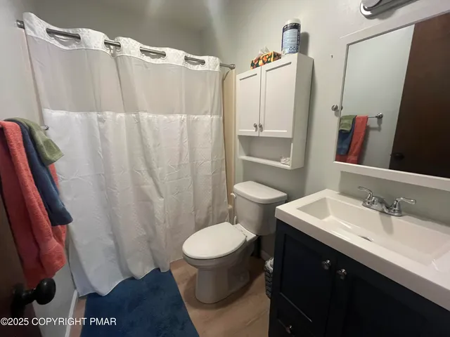 a living room with furniture a window and gym equipment