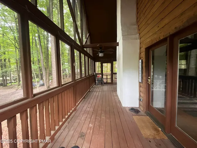 a view of balcony with wooden floor and fence