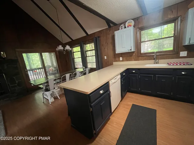 a large kitchen with a sink window and cabinets