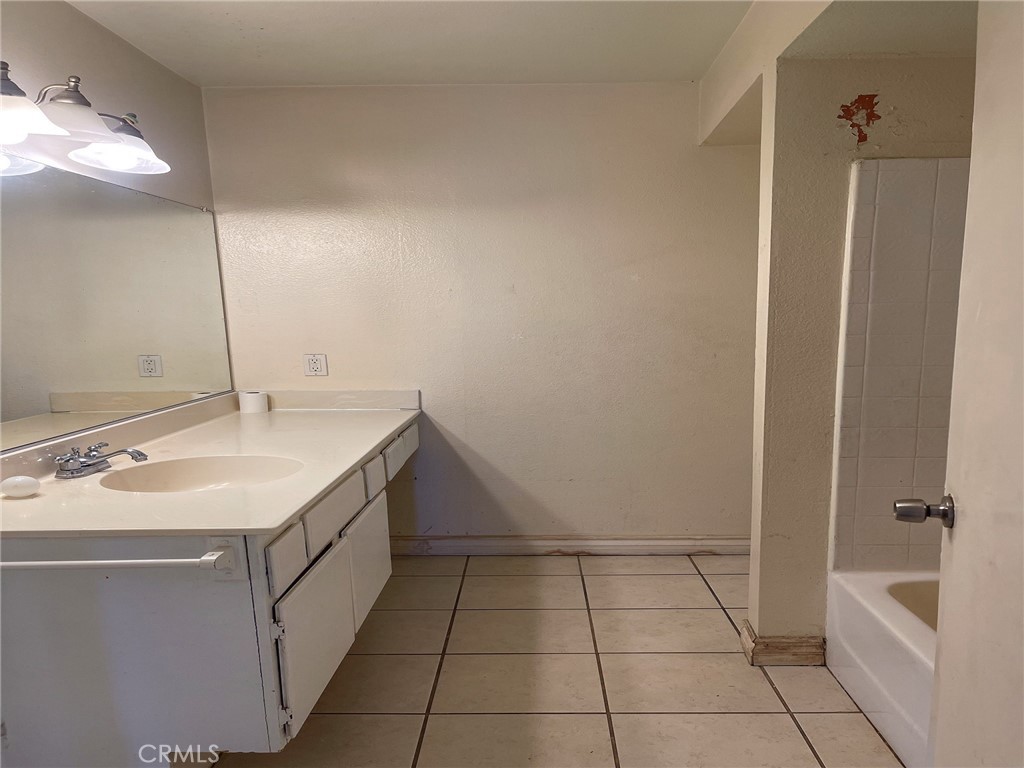 95 Country Mile Road, Unit 245 Pomona, CA 91766 - Photo 17 of 19 a bathroom with a sink a vanity and a mirror