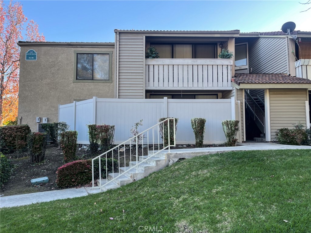 95 Country Mile Road, Unit 245 Pomona, CA 91766 - Photo 19 of 19 a view of a house with a yard and deck