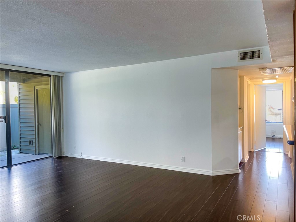95 Country Mile Road, Unit 245 Pomona, CA 91766 - Photo 8 of 19 a view of a hallway with wooden floor