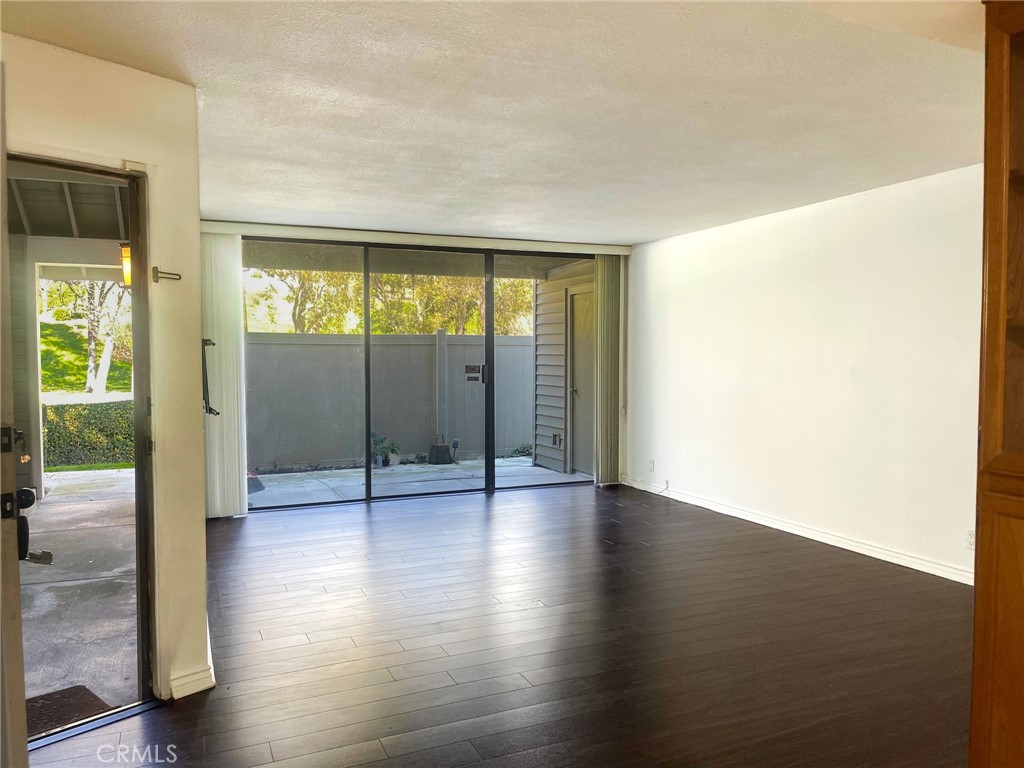 95 Country Mile Road, Unit 245 Pomona, CA 91766 - Photo 10 of 19 a view of an empty room with wooden floor and a window