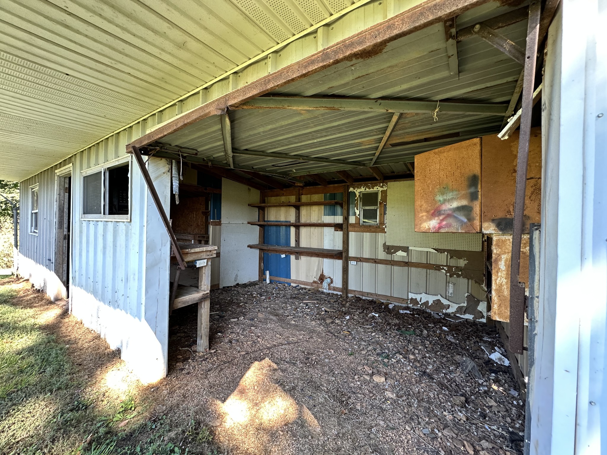 360 Coker Ford Road Portland, TN 37148 - Photo 19 of 46 a view of a backyard with table and chairs under an umbrella