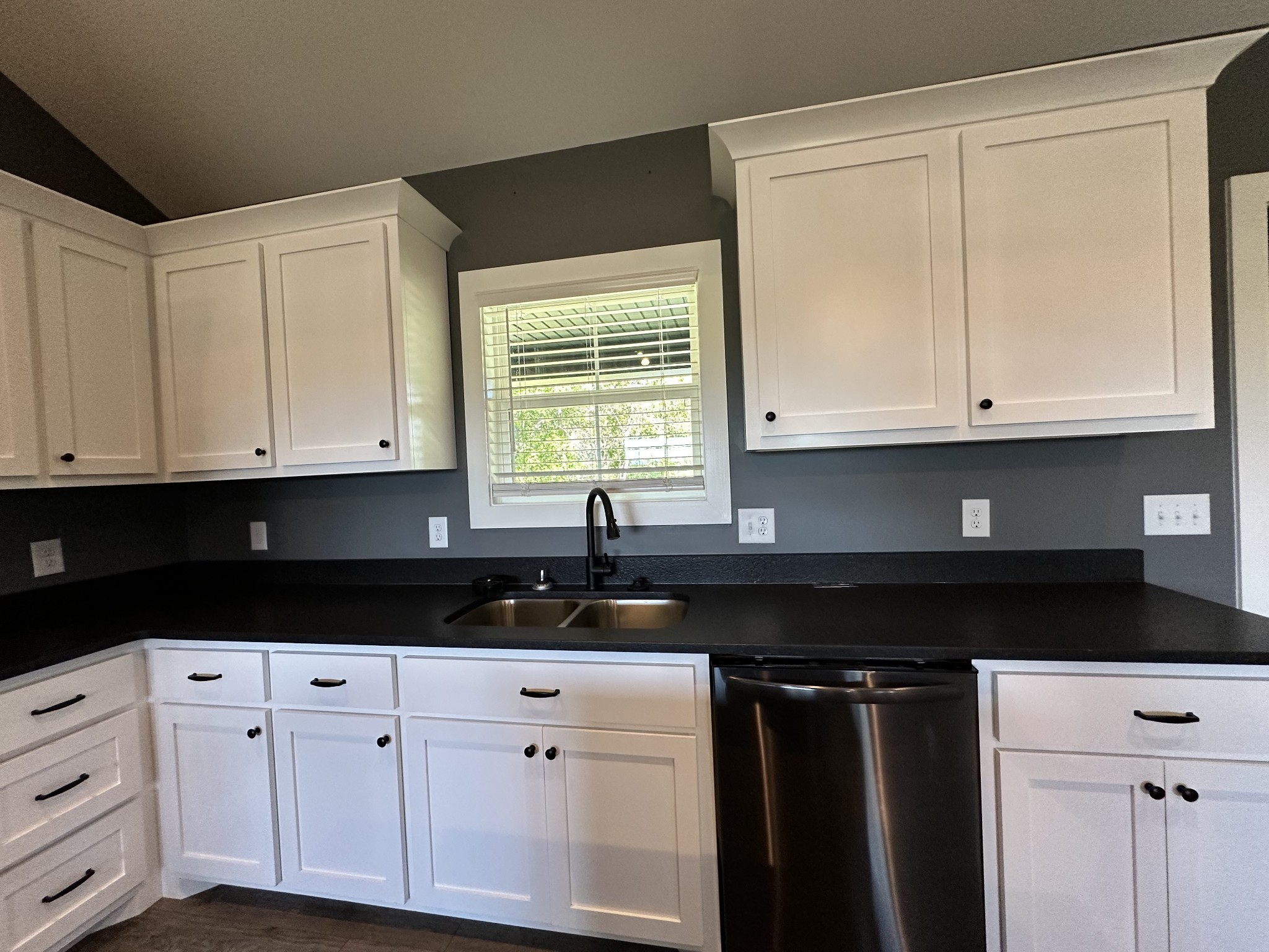 360 Coker Ford Road Portland, TN 37148 - Photo 32 of 46 a kitchen with granite countertop white cabinets and black appliances