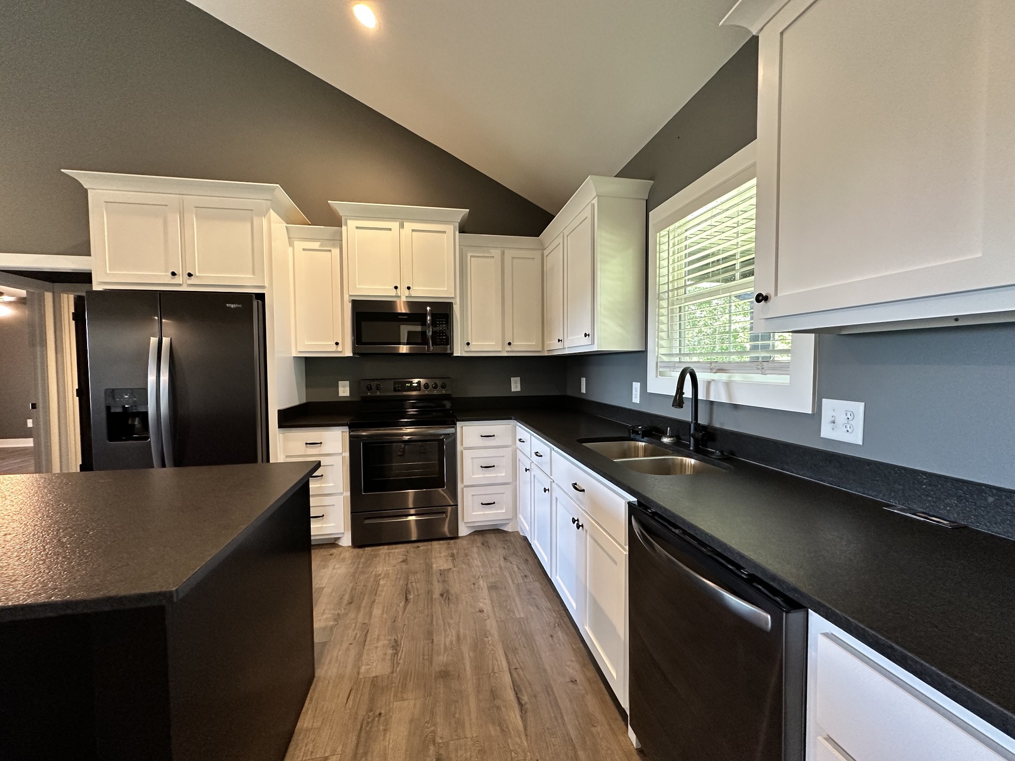 360 Coker Ford Road Portland, TN 37148 - Photo 33 of 46 a kitchen with stainless steel appliances granite countertop a sink a stove and refrigerator