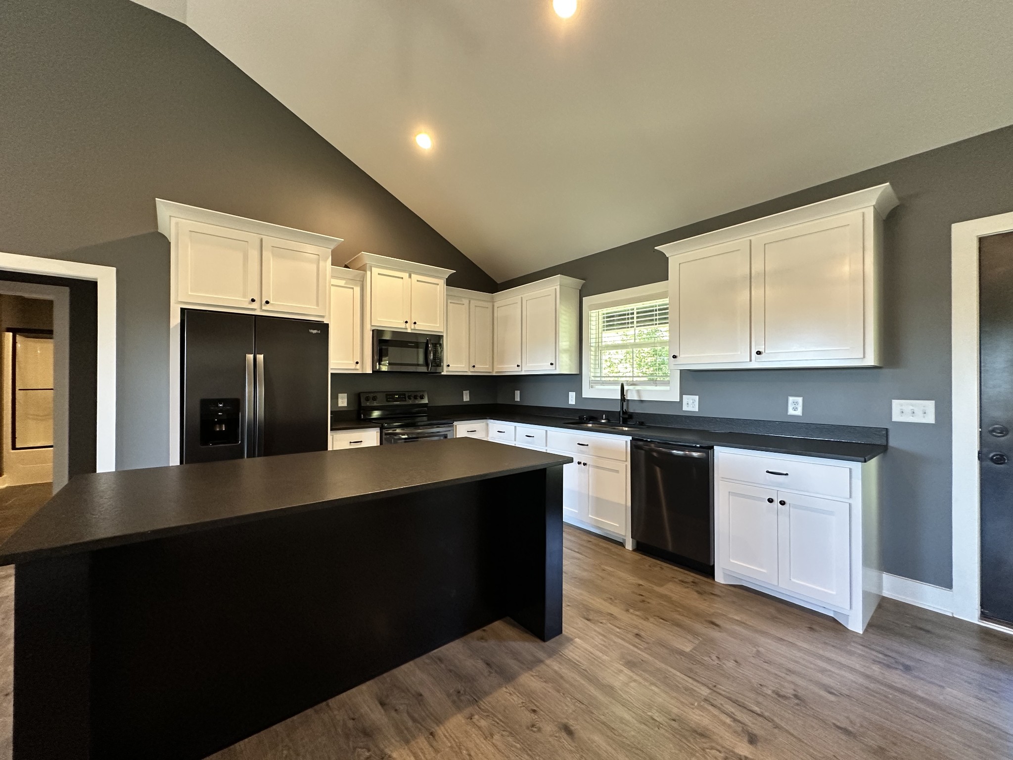 360 Coker Ford Road Portland, TN 37148 - Photo 34 of 46 a kitchen with stainless steel appliances granite countertop a sink dishwasher a stove a refrigerator a sink with wooden cabinets and wooden floor