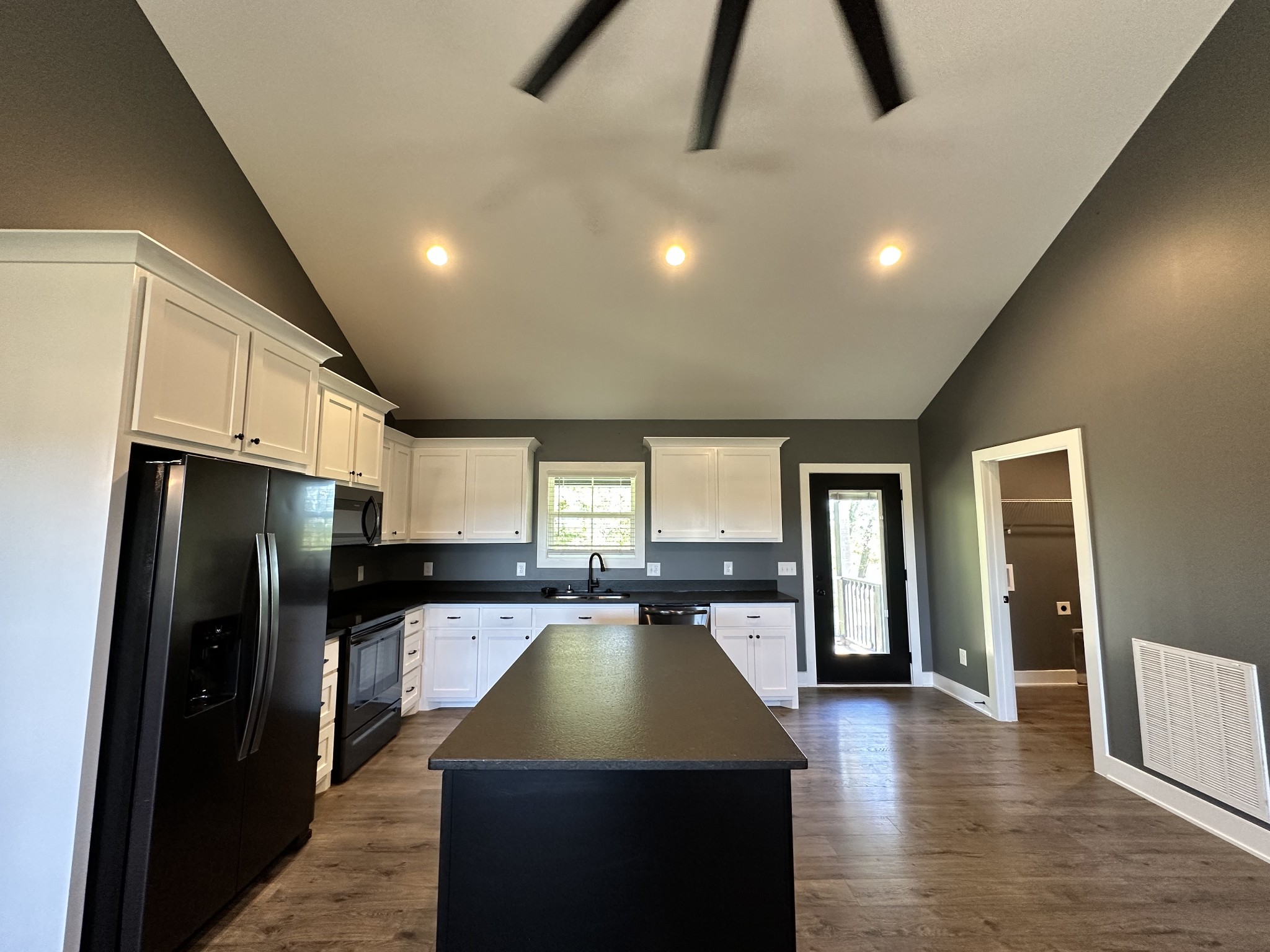 360 Coker Ford Road Portland, TN 37148 - Photo 36 of 46 a kitchen with stainless steel appliances granite countertop a refrigerator a sink dishwasher and a stove with wooden floor