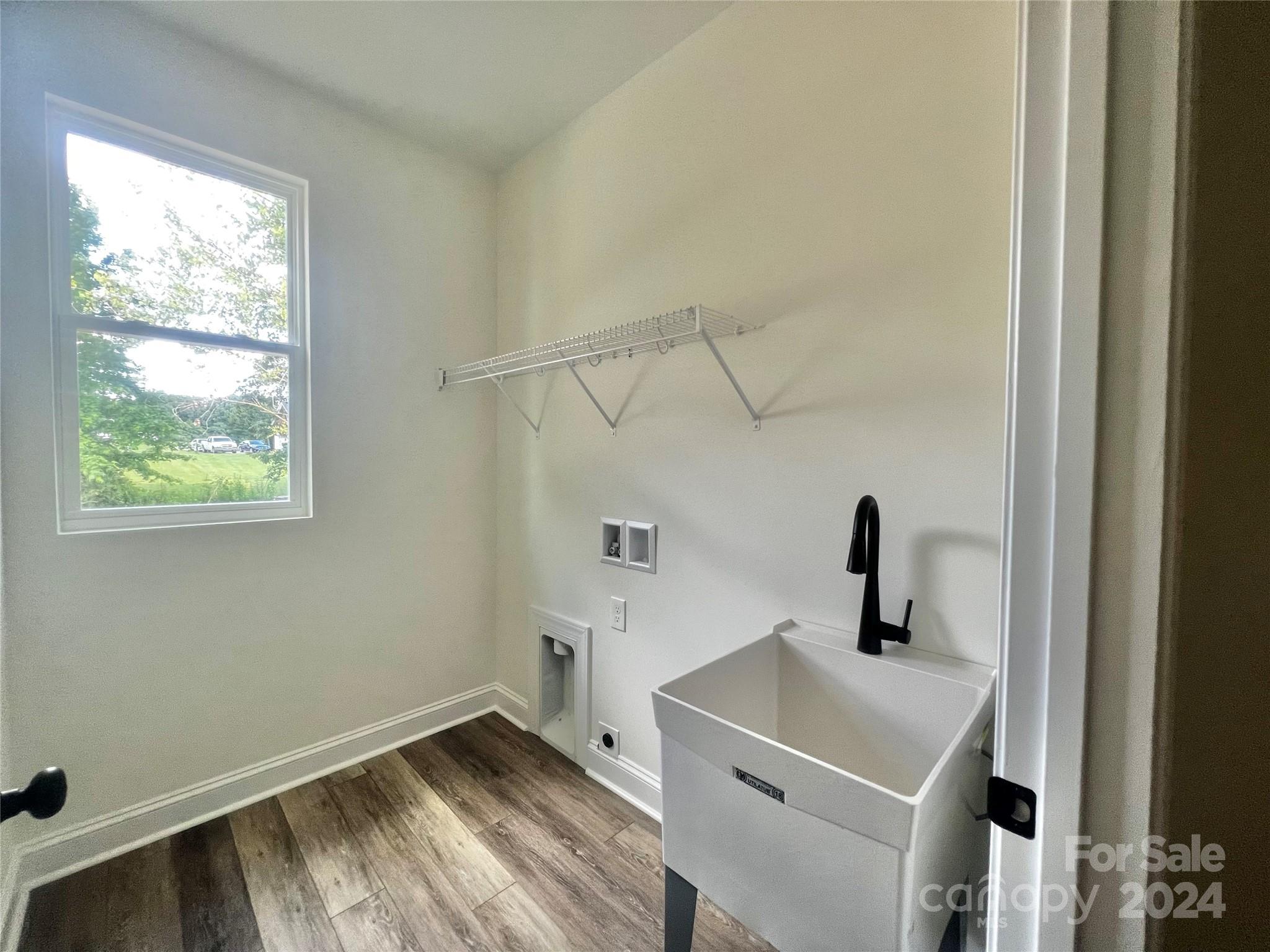 2709 Lathan Road Monroe, NC 28112 - Photo 11 of 26 a bathroom with a sink and a window