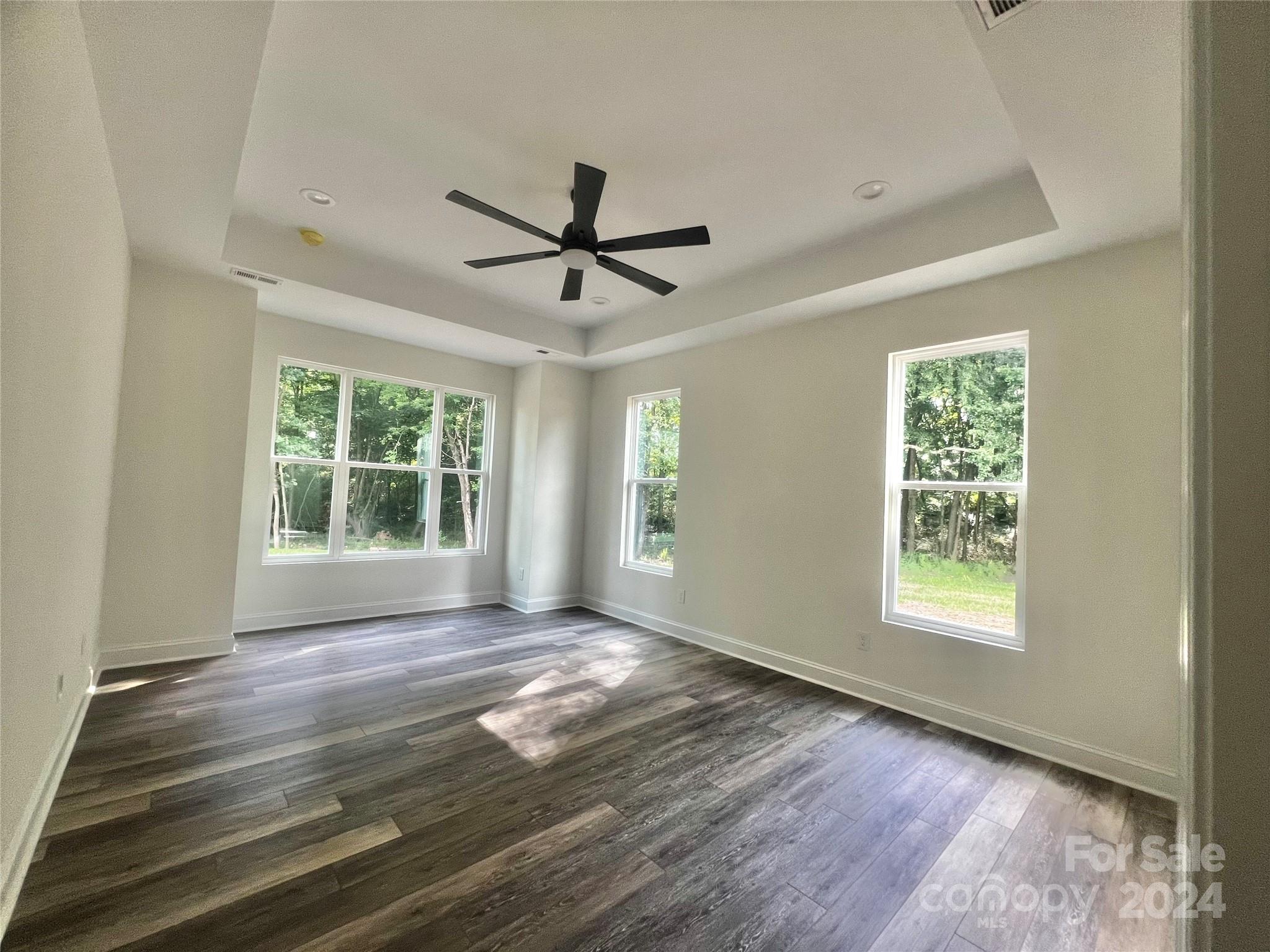 2709 Lathan Road Monroe, NC 28112 - Photo 12 of 26 a view of an empty room with window and wooden floor