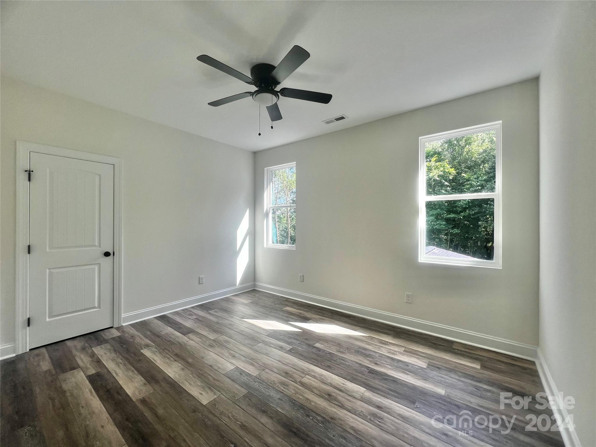 2709 Lathan Road Monroe, NC 28112 - Photo 17 of 26 a view of a big room with wooden floor and windows in a room