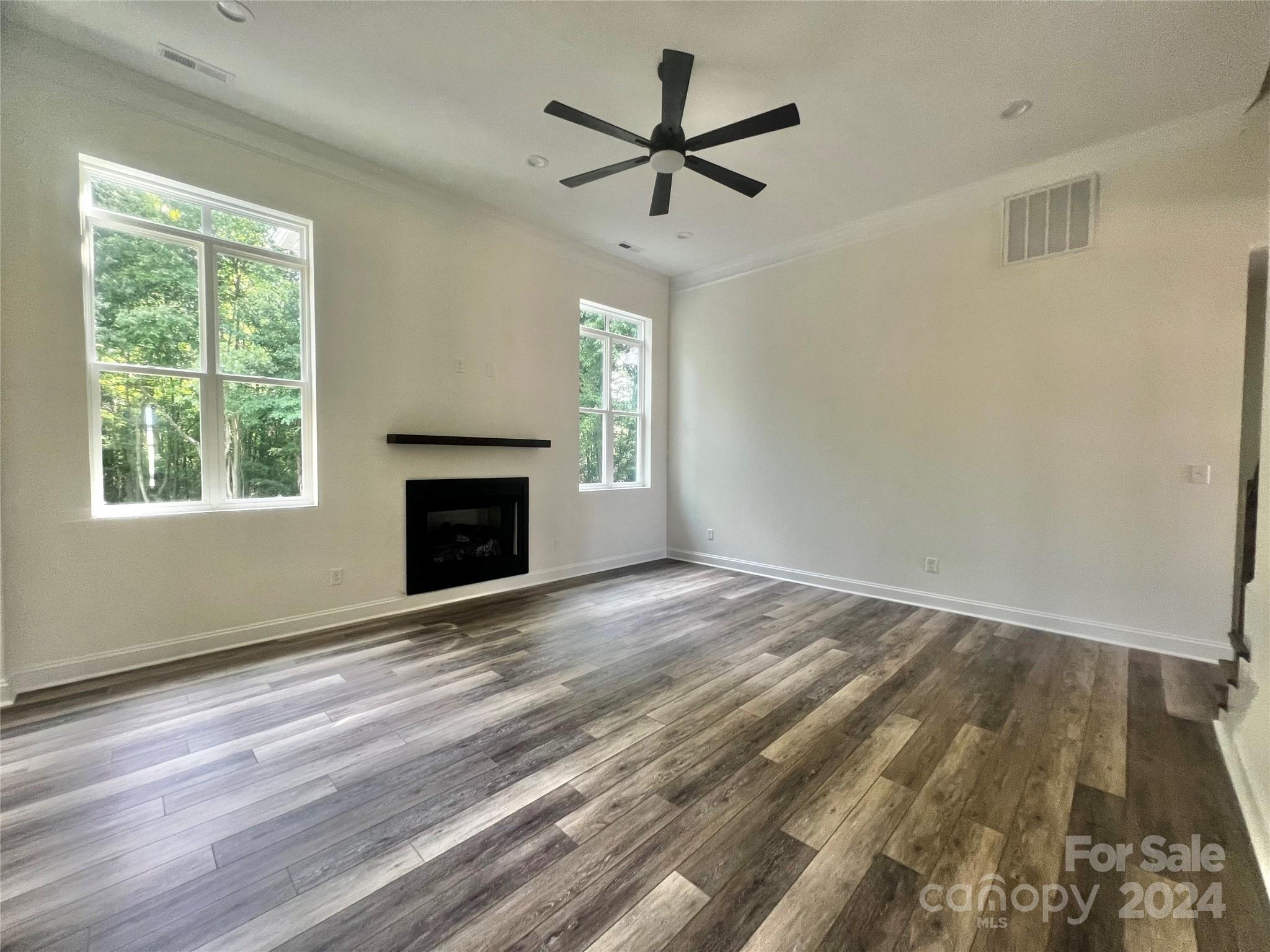 2709 Lathan Road Monroe, NC 28112 - Photo 20 of 26 a view of empty room with wooden floor and fan