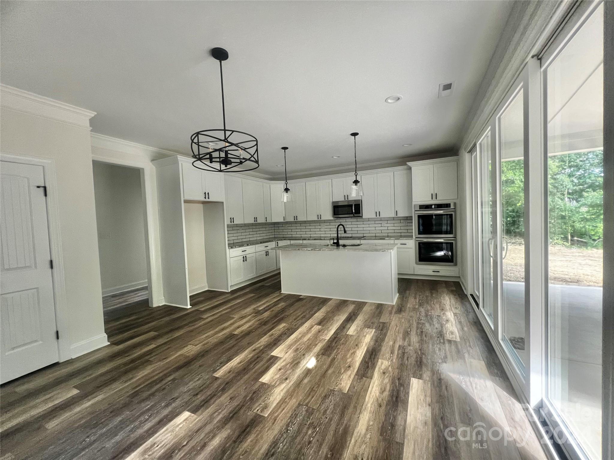 2709 Lathan Road Monroe, NC 28112 - Photo 4 of 26 a kitchen with stainless steel appliances granite countertop a refrigerator and a sink