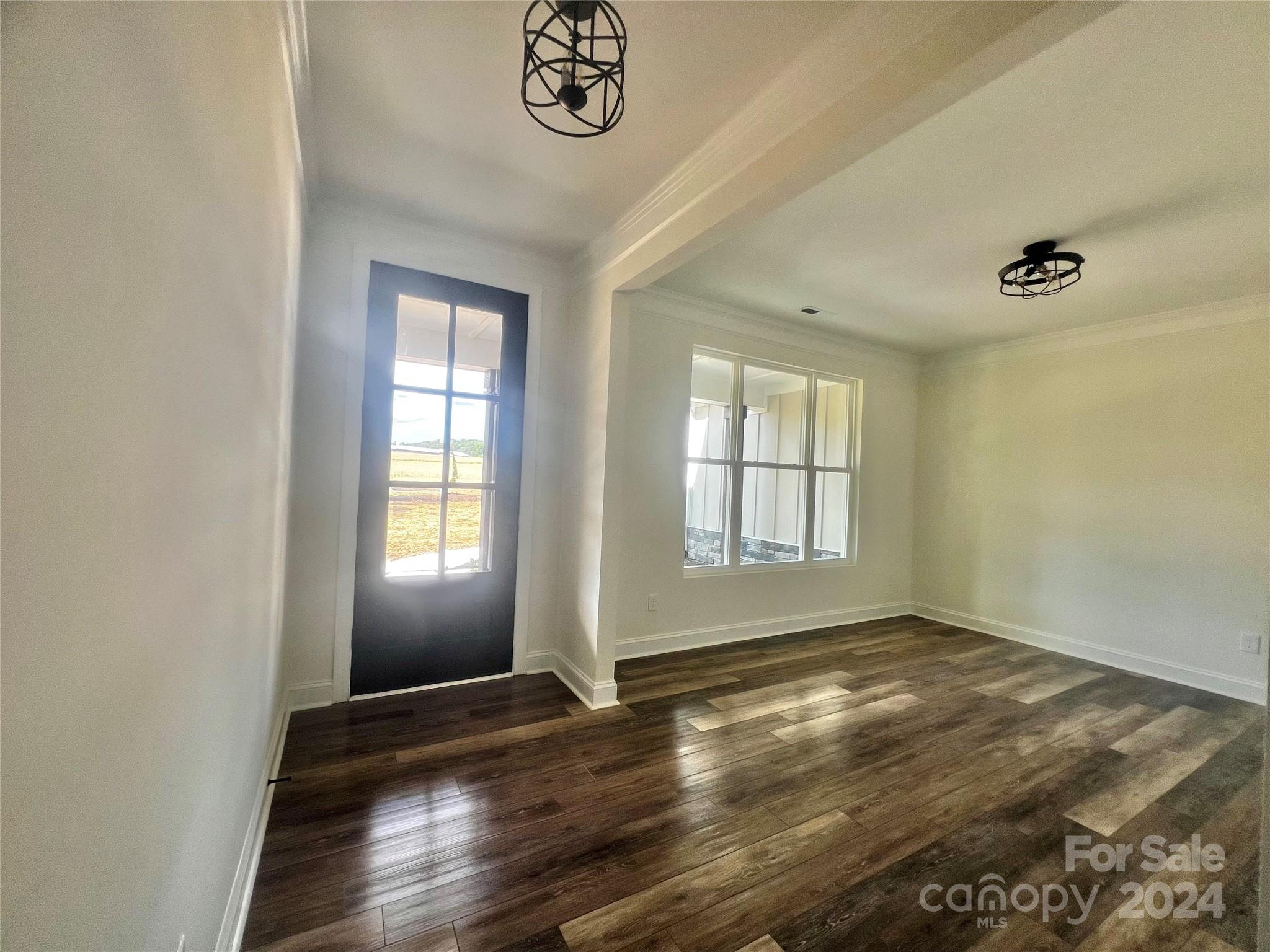 2709 Lathan Road Monroe, NC 28112 - Photo 7 of 26 a view of an empty room with window and wooden floor