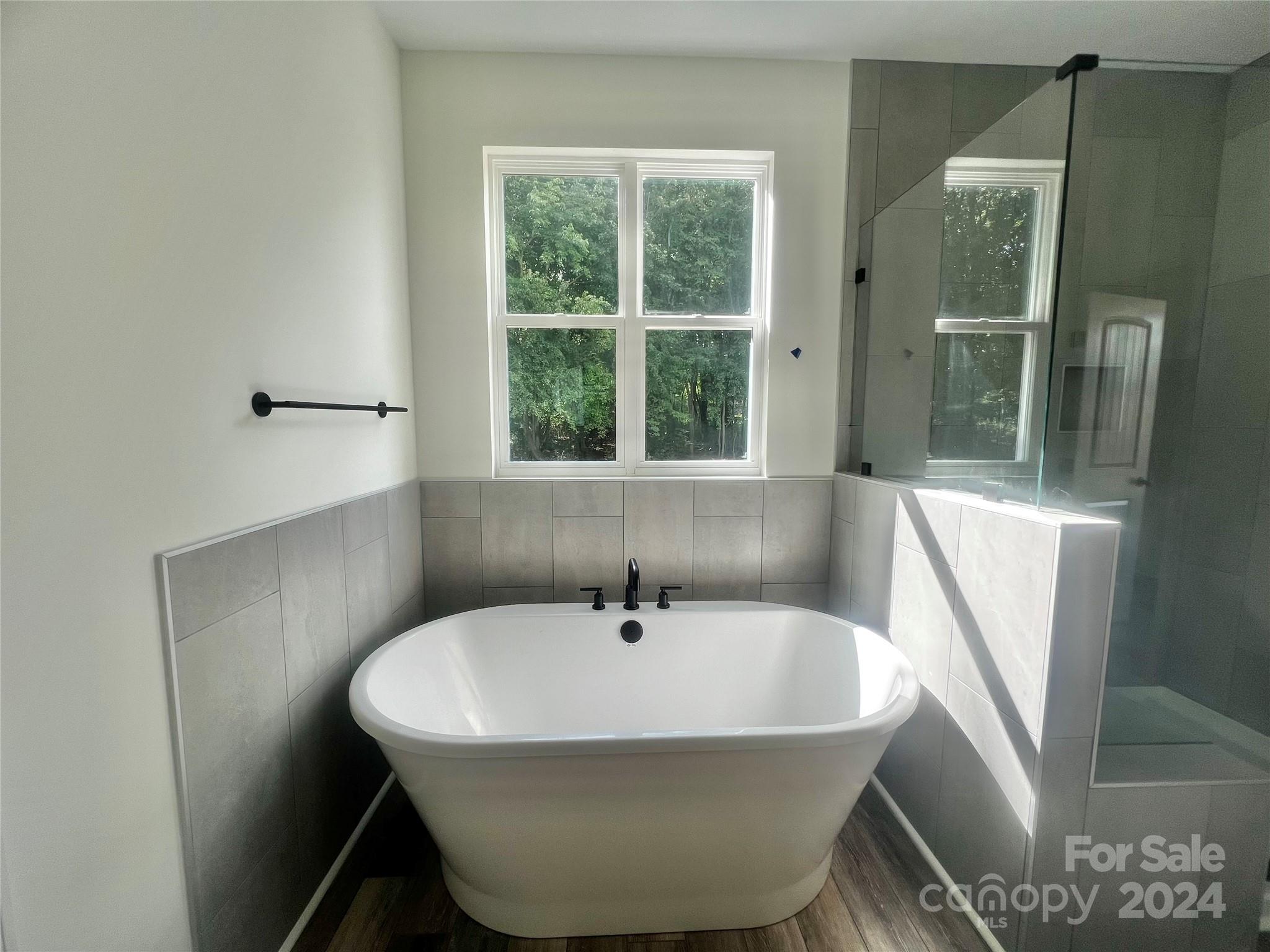 2709 Lathan Road Monroe, NC 28112 - Photo 9 of 26 a white bath tub sitting next to a window