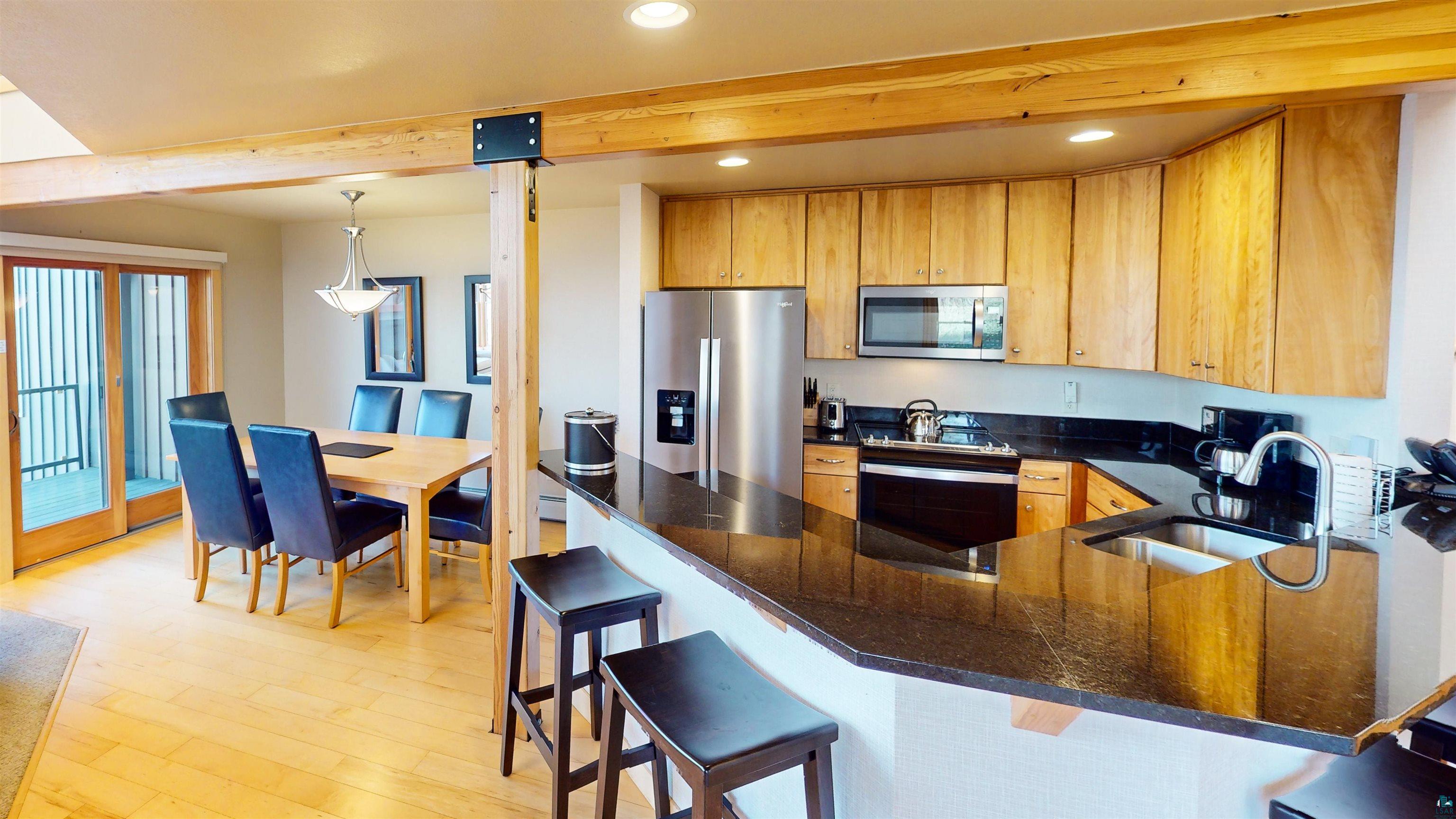 40 Surfside Drive, Unit 5D Tofte, MN 55615 - Photo 31 of 37 Open-concept kitchen and dining area featuring light wood-finish flooring