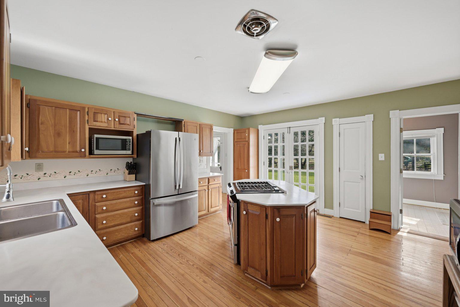 171 Laurel Grove Road Winchester, VA 22602 - Photo 15 of 83 a kitchen with stainless steel appliances granite countertop a refrigerator a sink dishwasher a stove with wooden floors and a dining table