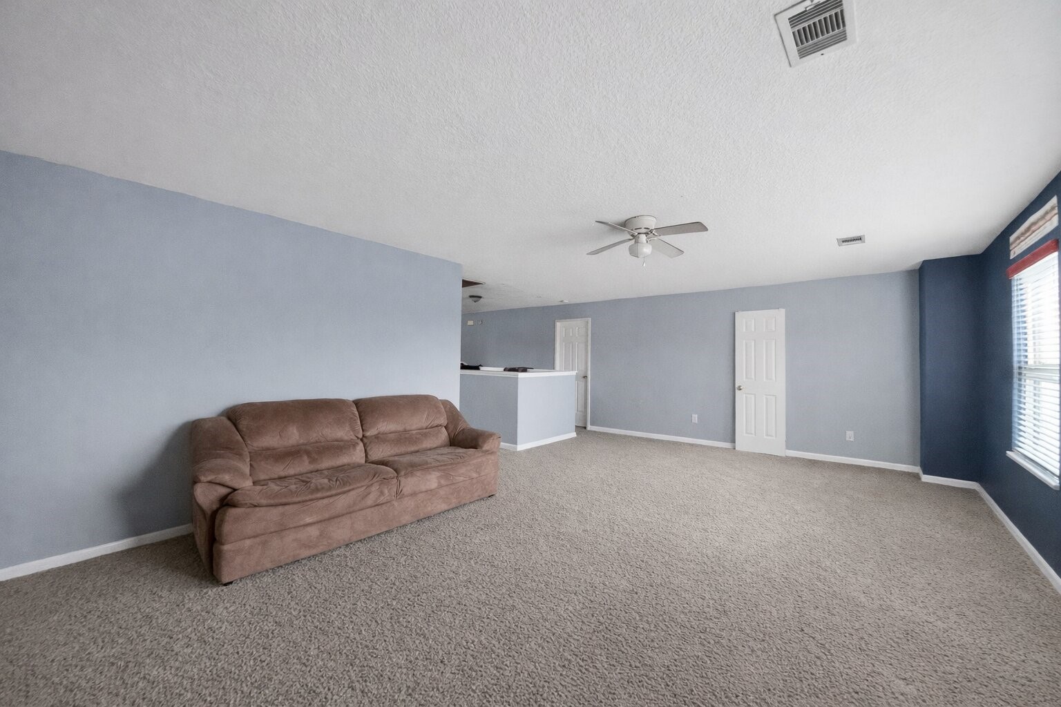 7902 Sesame Street Baytown, TX 77521 - Photo 21 of 24 a living room with furniture and a chandelier