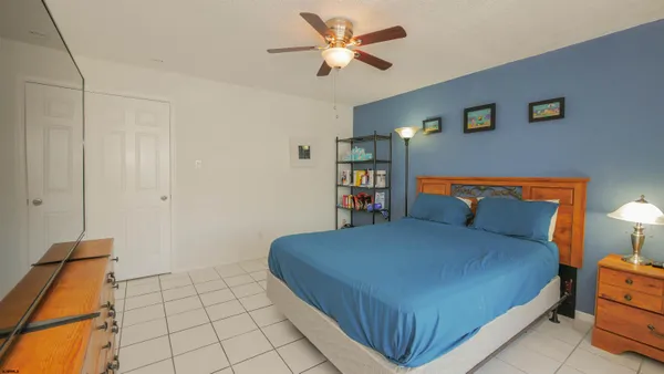 a bedroom with a bed and a book shelf