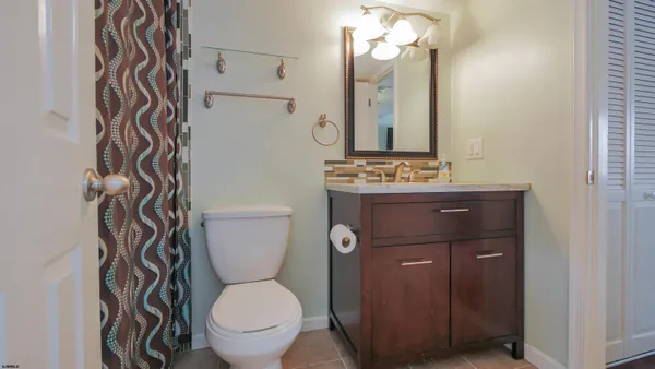 a bathroom with a toilet a sink and a mirror
