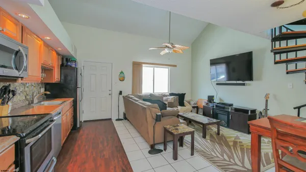 a living room with fireplace furniture and a flat screen tv