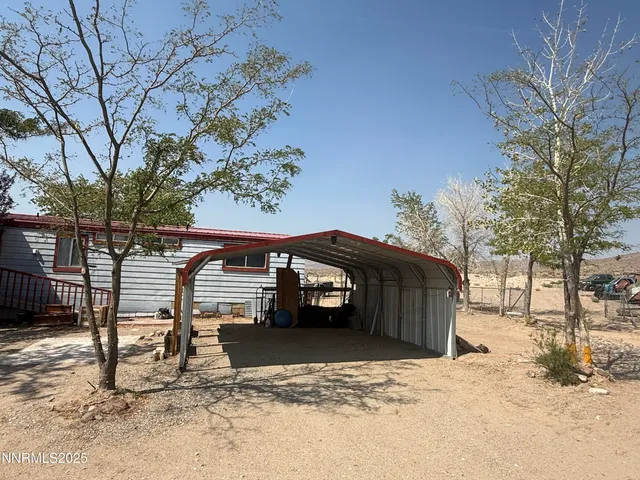 a view of a house with a snow in the yard