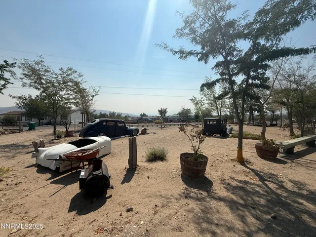 a view of a lake with chairs and barbeque