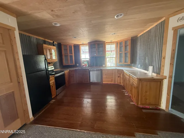 a kitchen with stainless steel appliances granite countertop a refrigerator a sink and a stove