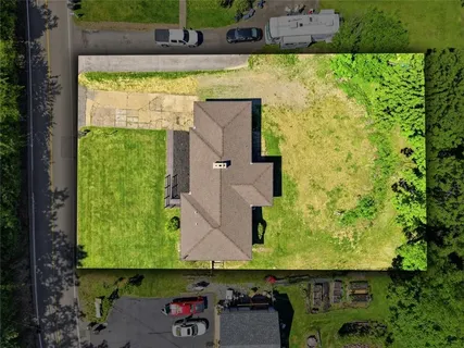an aerial view of a house with a yard