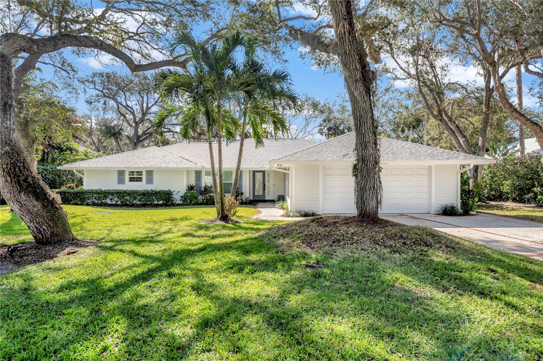 a view of a house with a yard and tree